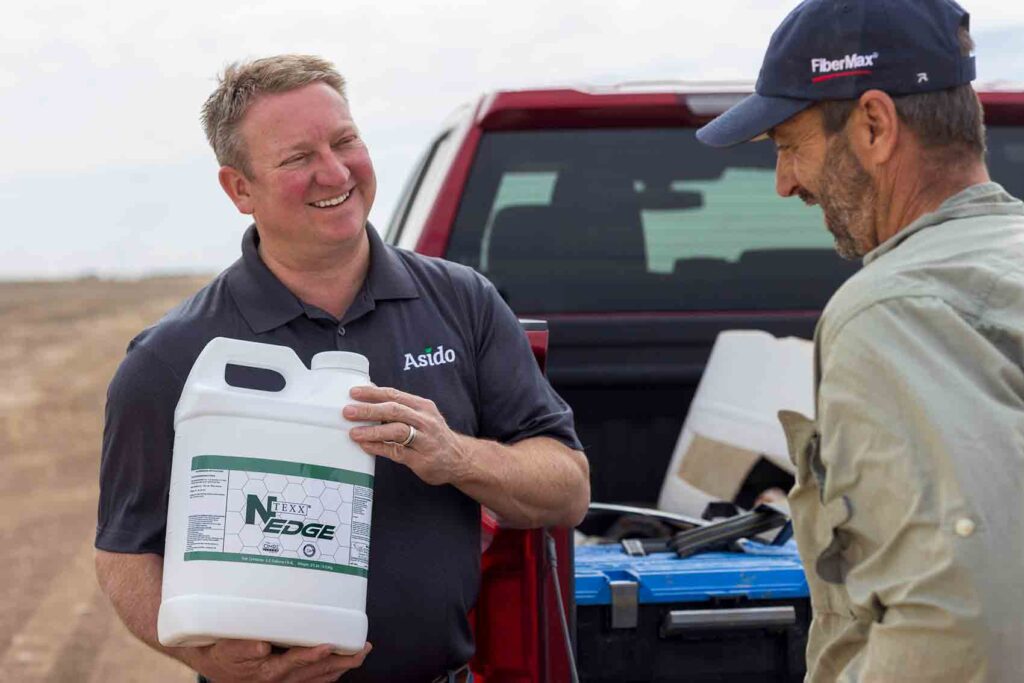 Team member showing NTEXX Edge product to a farmer.